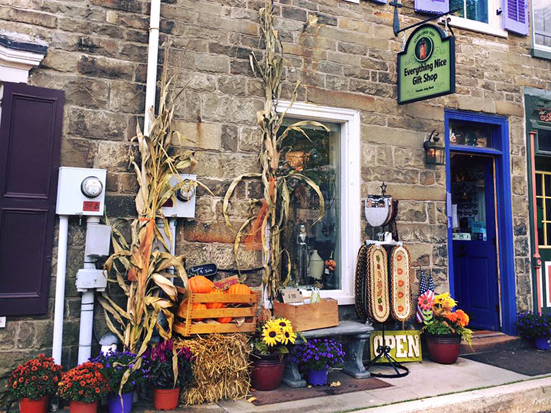 Exterior signage and fall display outside Everything Nice Gift Shop in Jim Thorpe, PA.