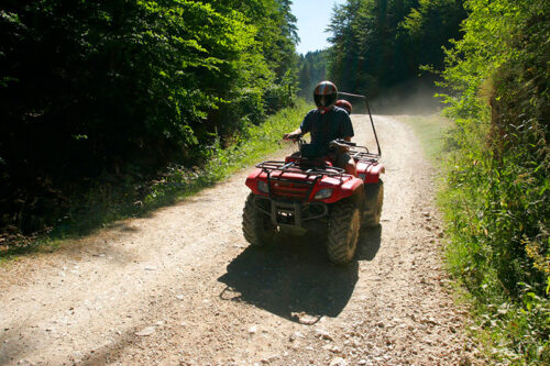 A single rider enjoys an ATV ride along one of the trails at Pocono ATVs at Memorytown in Mount Pocono, PA.