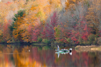 A fisherman casts a line from his boat on Lackawanna Lake at Lackawanna State Park in North Abington Twp., PA.