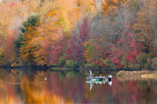 A fisherman casts a line from his boat on Lackawanna Lake at Lackawanna State Park in North Abington Twp., PA.