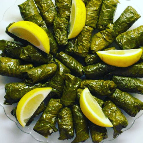 A large platter of stuffed grape leaves garnished with fresh lemon wedges from The Garden Mediterranean Cafe and Grill in Scranton, PA.