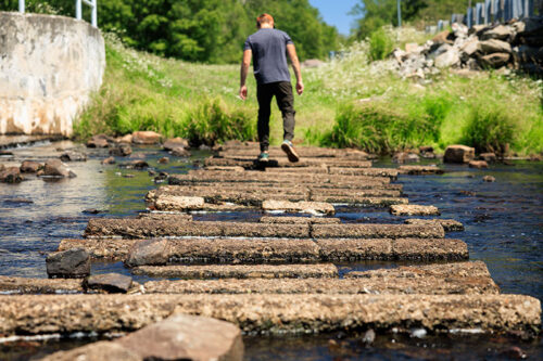 A man walks across a bridge at Tobyhanna State Park in Tobyhanna, PA.