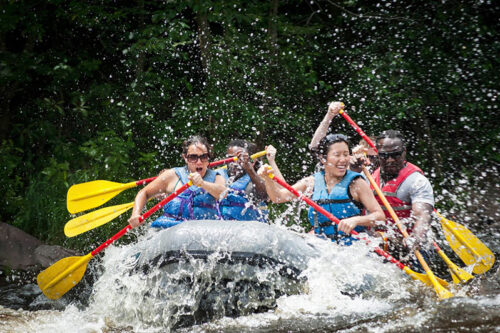 Several adults brave the rapids whitewater rafting in the Lehigh River in Northeastern, PA.