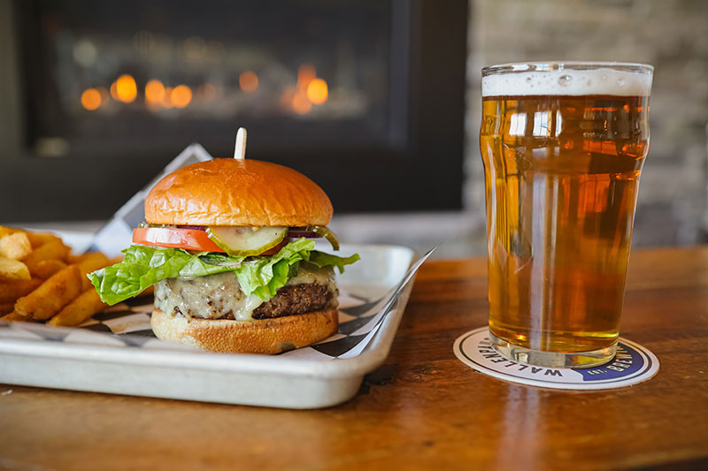 A burger and a beer on a table in the taproom at Wallenpaupack Brewing Company in Hawley, PA.