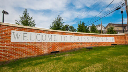 A brick wall with the words 'Welcome to Plains Township' engraved on it.