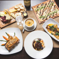 An overhead view of a healthy spread of food from Harvest Seasonal Grill and Wine Bar in Moosic, PA.