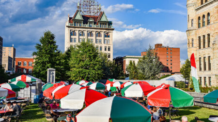 View of colorful umbrellas and the Electric City Sign on Courthouse Squarer at La Festa Italiana, a popular local festival in Scranton, PA.