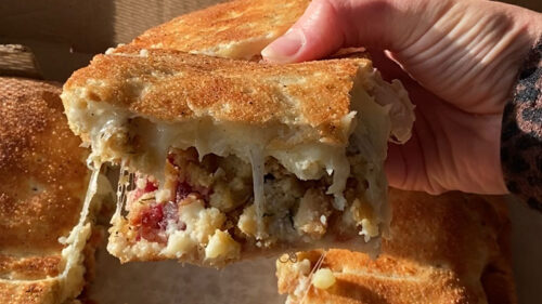 A thick, cheesy slice of the Double Crust Thanksgiving Pizza from Vidaro's Pizza & Bites in Peckville, PA.