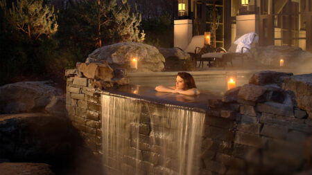 A woman relaxing in an outdoor infinity tub at The Lodge at Woodloch in Hawley, PA.
