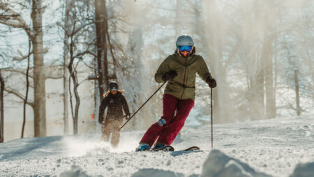 Two people skiing on a snowy slope at Montage Mountain Resort in Scranton, PA.