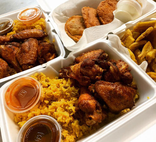 Four take-out containers filled with rice and meats from Papi's Kitchen on Wheels in Scranton, Pa.