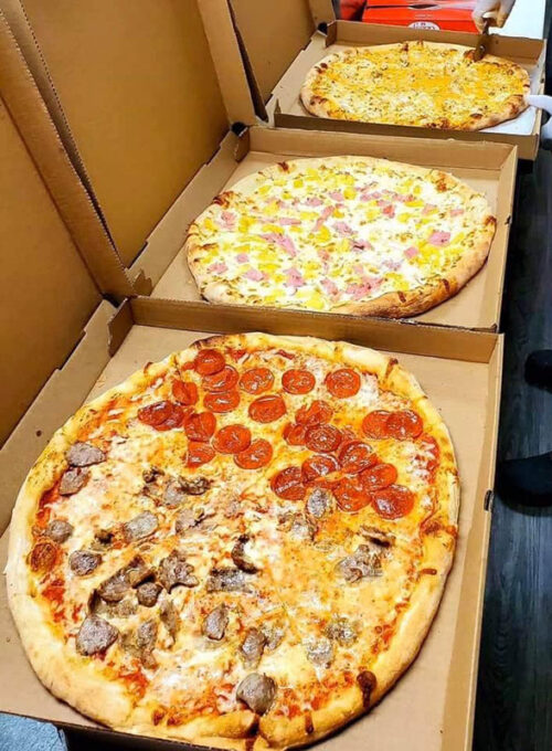Three pizzas lined up on the counter at Burrito Loco Pizza and Grill in Wilkes-Barre, PA.