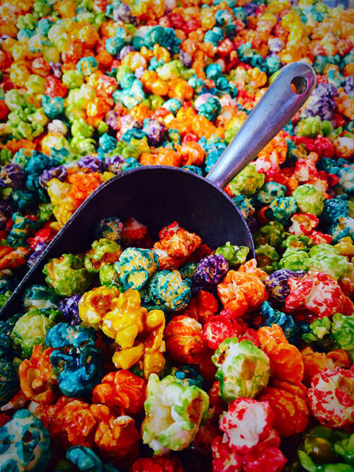 A metal scooper is filled with colorful popcorn from Incredible Popcorn in Bloomsburg, PA.