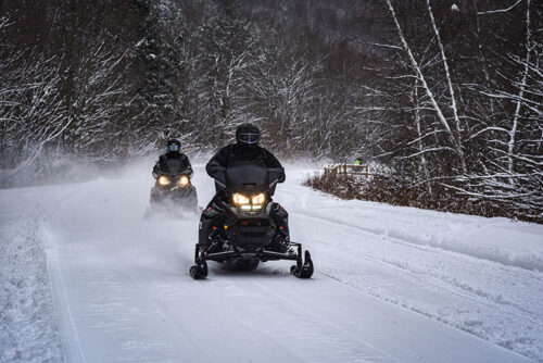 Snowmobilers cruise along the trail at NEPA Sno & ATV Trails in Forest City, PA.