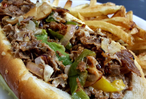 A cheesesteak with peppers with a side of fries from The Tipsy Turtle in Jenkins Twp., PA .