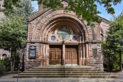 Large wooden doors and red stone archways mark the entrance of the First Presbyterian Church in Wilkes-Barre, PA.