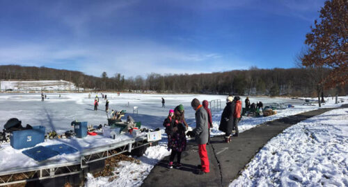 A group of people waiting to get on the ice at the outdoor ice skating rink at Hillside Park in South Abington Twp., PA.