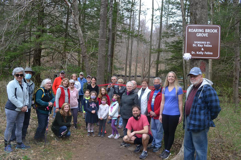 Twenty five members from the North Pocono Trails Association (senior citizens, adults and children) pose at the ribbon cutting of the Roaring Brook Grove section of the North Pocono Trail System in Moscow, PA.