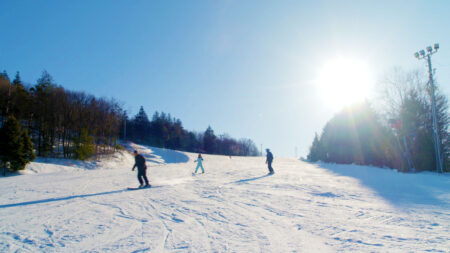 Skiers and snowboarders racing down the mountain at Blue Mountain Resort in Palmerton, PA.