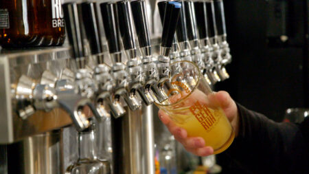 A bartender pours a fresh beer into a pint glass at Pilger Ruh Brewing in Pottsville, PA.