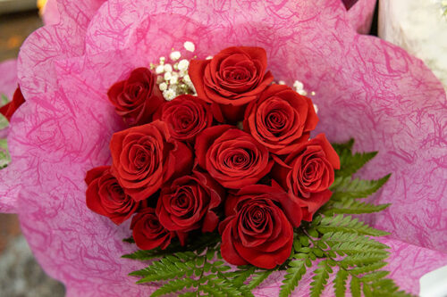 Red rose bouquet wrapped in pink paper from The Flower Warehouse in Forty Fort, PA.