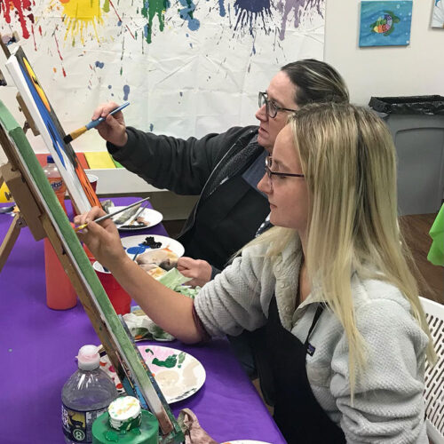 Two women painting on canvases at the Art Party Place in Mountain Top, PA.