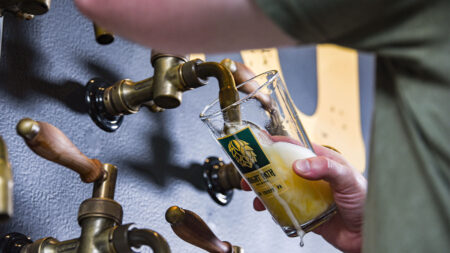 A bartender pours a pint from a side pull tap at Bright Path Brewing in Jim Thorpe, PA.
