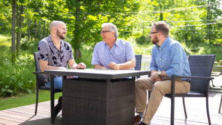 A father and two adult sons gather on an outdoor patio in Northeastern PA to celebrate Father's Day.