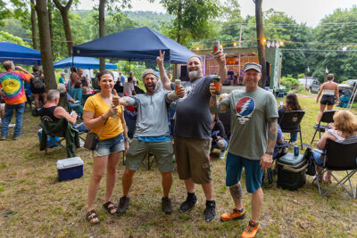 A group of people poses for a photo at the music festival at the giants Despair Hillclimb in Laurel Run, PA.