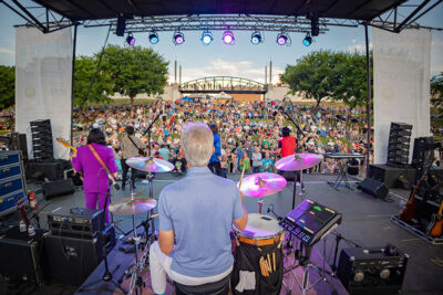 A view into the crowd from behind the drummer on stage at Wilkes-Barre's Rockin' the River Summer Concert Series at the River Common in Wilkes-Barre, PA.