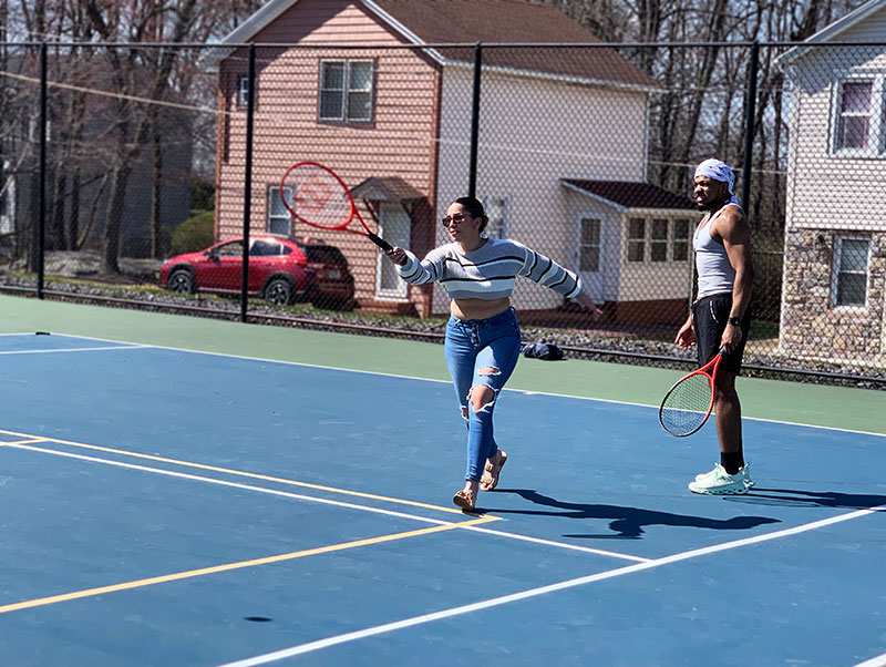 A man and a woman playing tennis at Altmiller Park in Hazleton, PA.