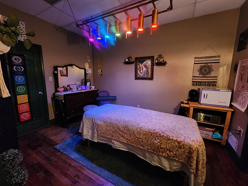 The massage room with multicolored lights over the massage table at Pure Rose Bodywork in Ringtown, PA.