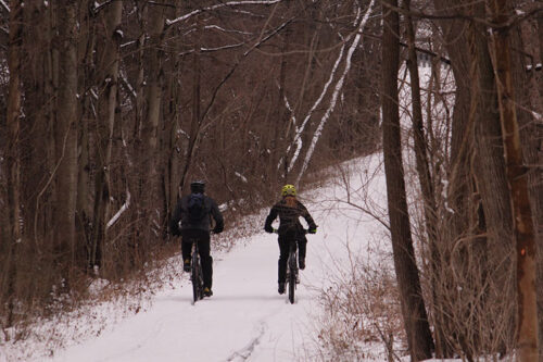 Two bikers ride along a snowy trail at Swatara State Park in Pine Grove, PA.