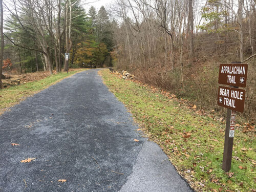 A sign indicates the directions to access the Appalachian and Bear Hole Trails at Swatara State Park in Pine Grove, PA.