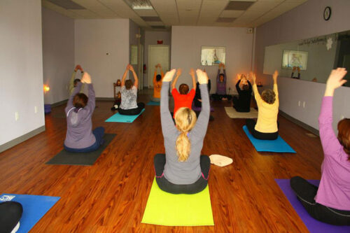 A group holds a pose during yoga class at The Yoga Studio in Wyoming, PA.