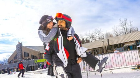 A man playfully carrying a woman on his back while they smile at each other at Montage Mountain Resort in Moosic, PA.