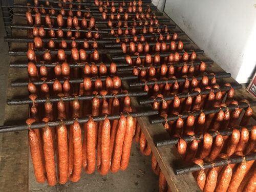 Rings of smoked Kielbasi hang on racks at Rehoski Market in Duryea, PA.