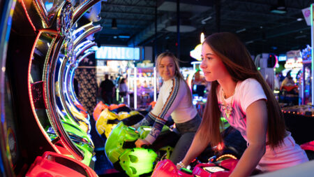 Two girls on the riding games at Dave and Busters in Moosic, PA.