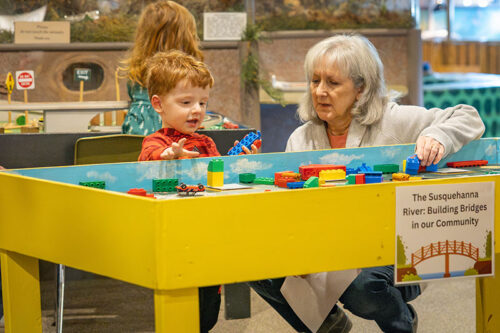 Woman and child exploring the Bloomsburg Children's Museum, a popular indoor activity for kids and toddlers in Bloomsburg, PA.