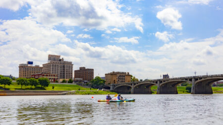 A pair of kayakers on the Susquehanna RIver paddle toward the Market Street Bridge Bridge in Wilkes-Barre, PA.