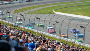 Race cars driving around a corner on the tricky triangle at Pocono Raceway during NASCAR Weekend in Long Pond, PA.