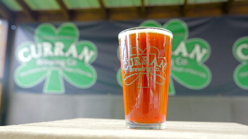 A pint of beer sits on a table on the outdoor patio at Curran Brewing Company in Madison Twp., PA.