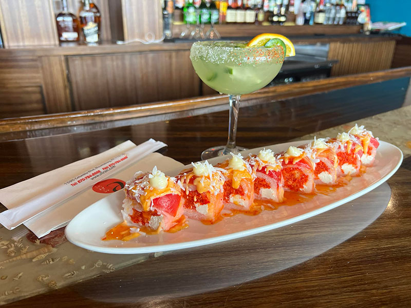 Cocktail and platter of sushi sit on the bar at Oliran Japanese Restaurant in Bloomsburg, PA.