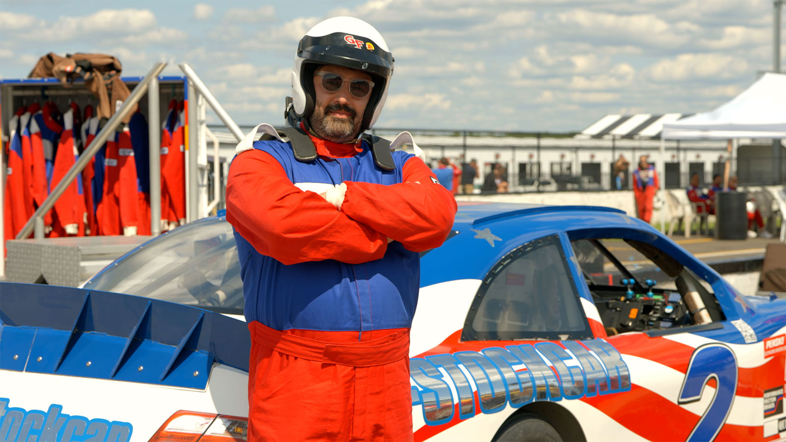 A man leaning against a car during the Stock Car Racing experience in Long Pond, PA.