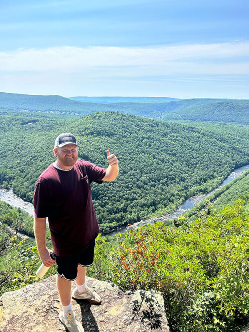 A young man poses for a photo at a scenic overlook from a trail at Lehigh Gorge State Park in Weatherly, PA.