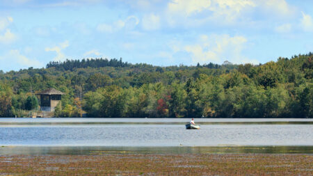 A man out on the lake fishes from his boat at Gouldsboro State Park in Gouldsboro, PA.