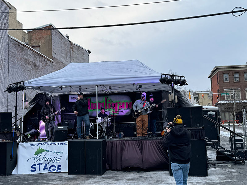 A band performs on an erected stage in downtown Pottsville. 