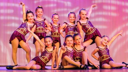 Dancers from the Joan Harris Centre in Luzerne, PA, a popular studio for kids’ dance classes, pose on stage.