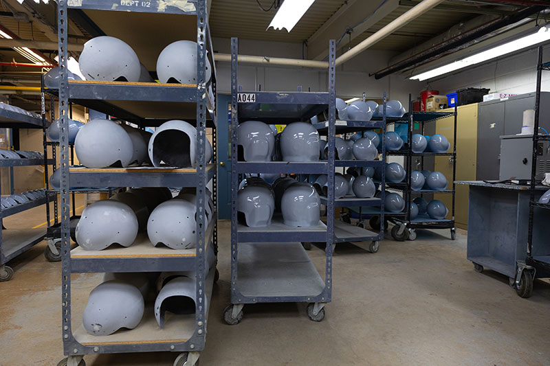 Metal shelves hold aircrew helmet shells. 