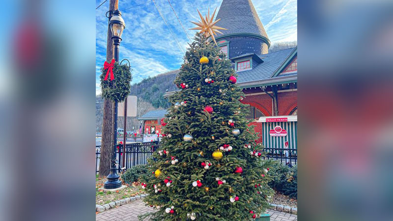 A decorated Christmas tree stands outside the historic train station during the Jim Thorpe Community Tree Lighting Ceremony in Jim Thorpe, PA.